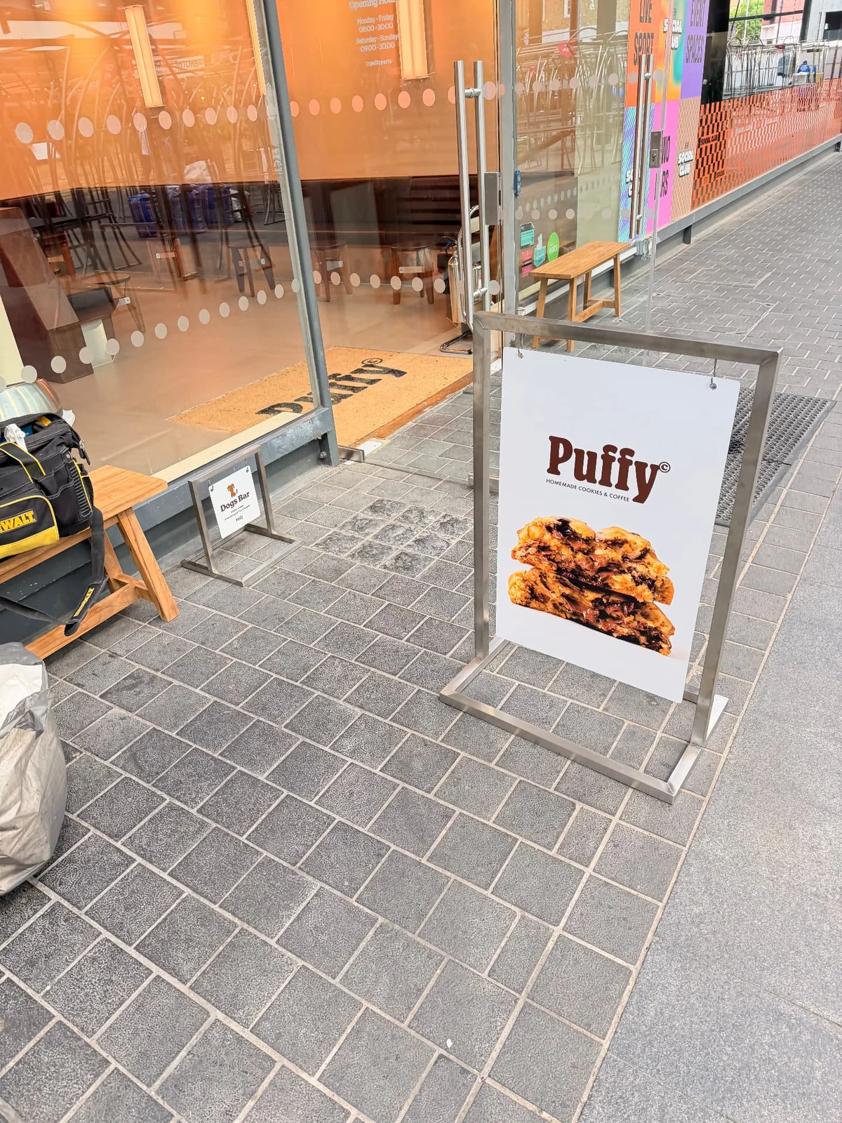 Puffy pavement sign, small floor stand and branded doormat beside glazed entrance doors