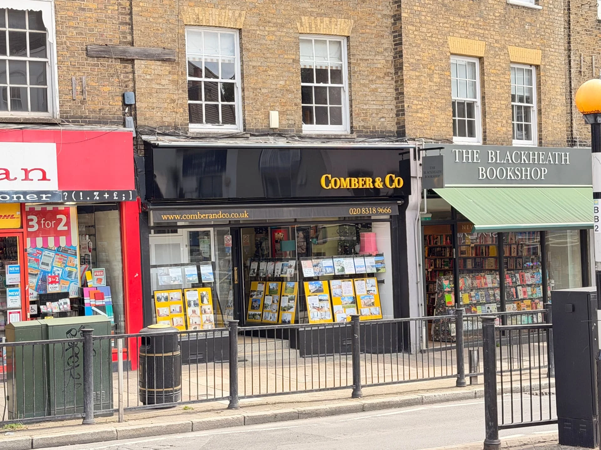 Completed Comber & Co fascia with refurbished lettering and external trough lighting, showing the shopfront beside neighbouring shops in Blackheath