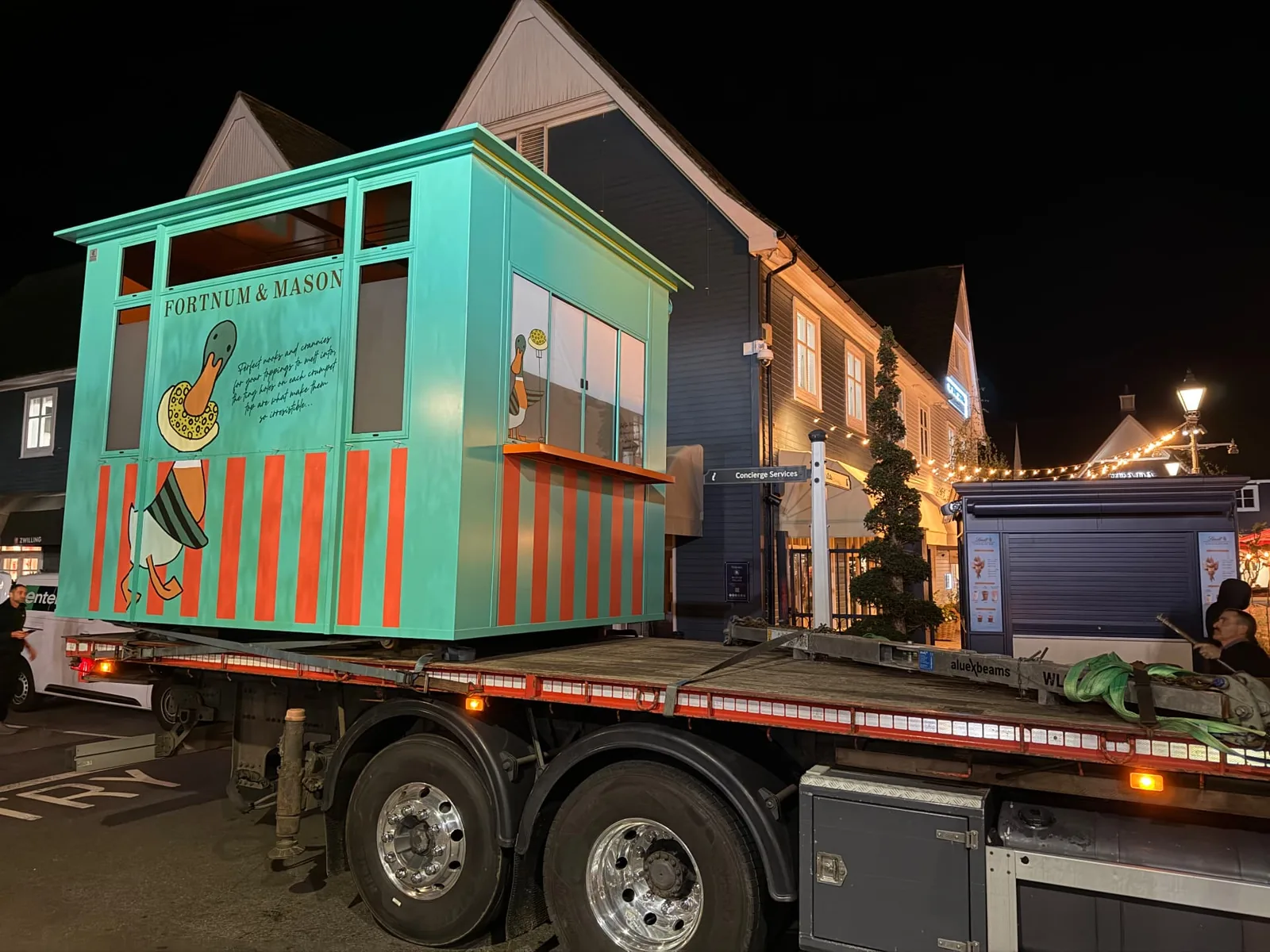 Fortnum & Mason kiosk on the back of a delivery lorry at night, arriving at Bicester Village