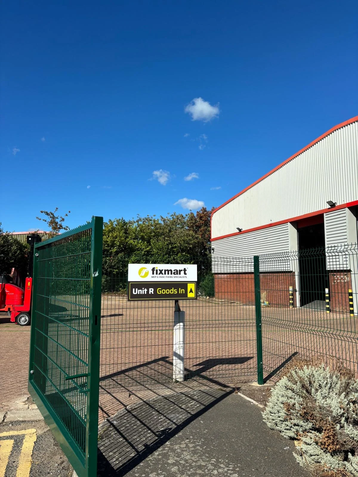 Fixmart Unit R goods-out sign beside the gated access