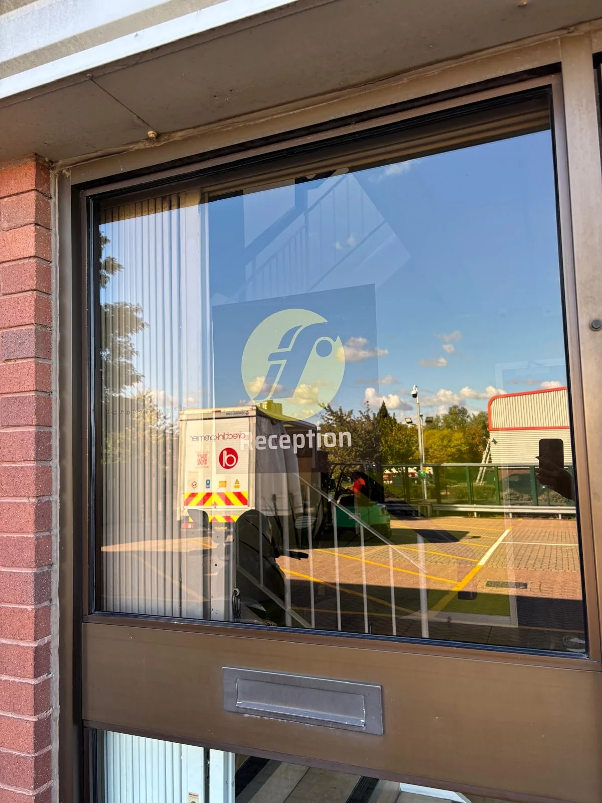 Fixmart logo and reception lettering on a glazed entrance door