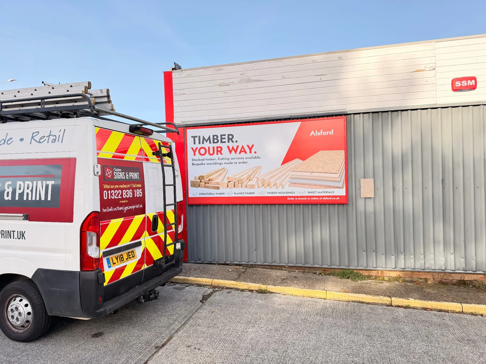 Custom Signs & Print vehicle beside an installed Alsford billboard