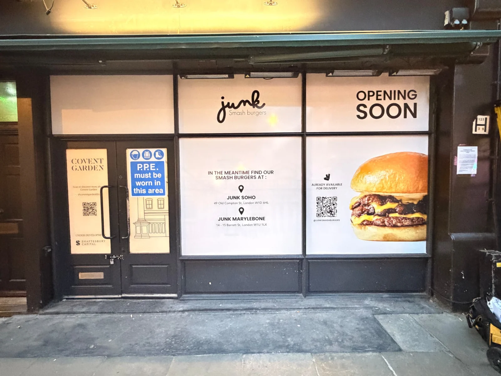 Junk printed opening-soon window graphics on a Covent Garden shopfront